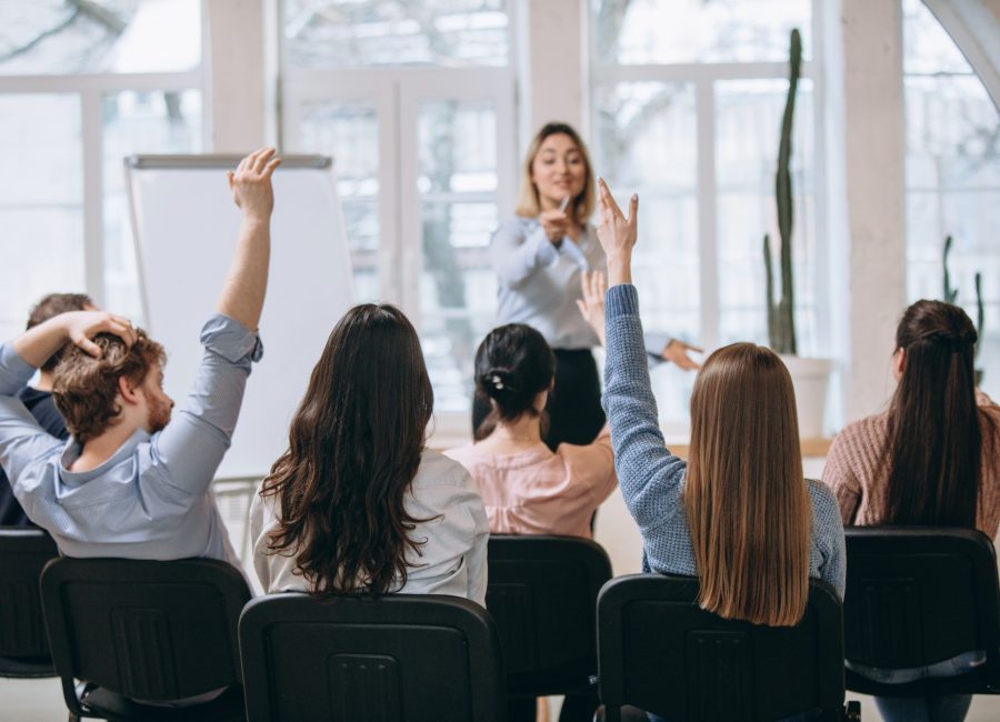 female-speaker-giving-presentation-hall-university-workshop-audience-conference-hall